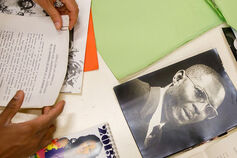 Material from the Black Film Center archive is layed out on a table.